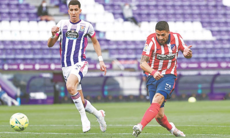 VALLADOLID: Atletico Madrid’s Luis Suarez scores the title-clinching goal during the La Liga match against Real Valladolid at the Estadio Jose Zorrilla.—Reuters VALLADOLID: Atletico Madrid’s Luis Suarez scores the title-clinching goal during the La Liga match against Real Valladolid at the Estadio Jose Zorrilla.—Reuters