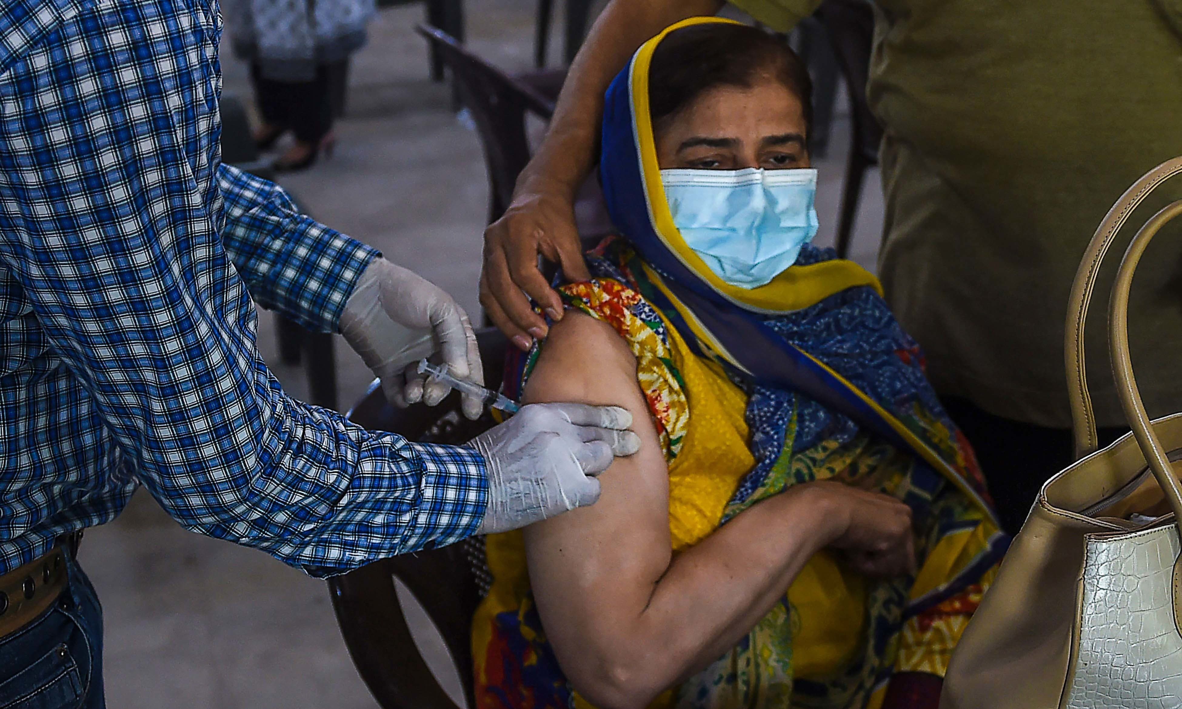 A woman receives a dose of the Covid-19 coronavirus Sinopharm vaccine at a vaccination camp in Karachi on May 25. — AFP