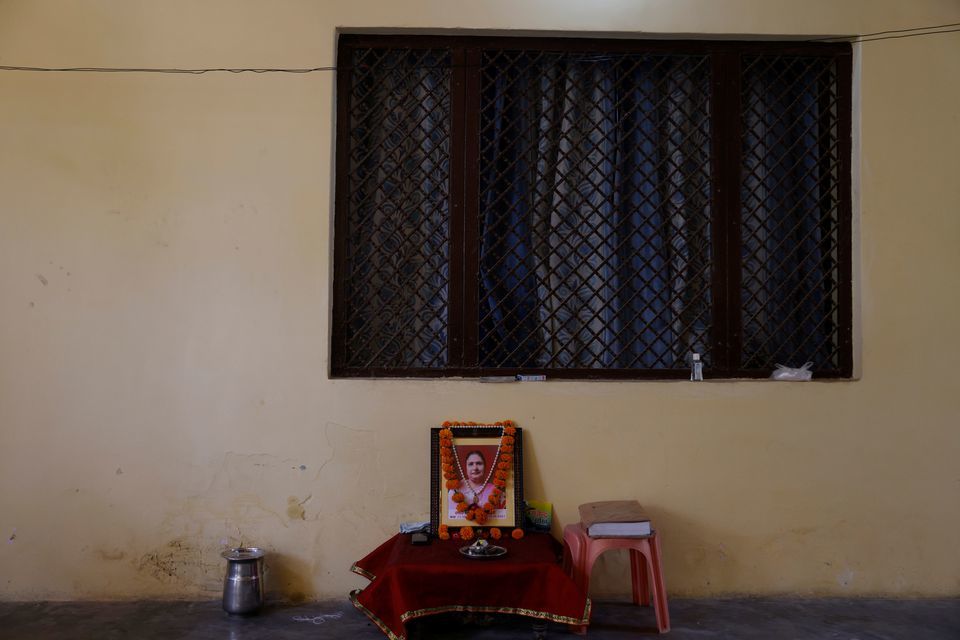 A garland is seen on a photo of Suman Lata, a teacher who died from Covid-19 after she attended her local election duty in April, in the town of Vrindavan in the northern state of Uttar Pradesh, India, May 25. &mdash; Reuters