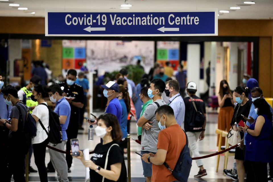 People wait in line to receive AstraZeneca's Covid-19 vaccine at a vaccination centre in Kuala Lumpur, Malaysia, May 5. — Reuters