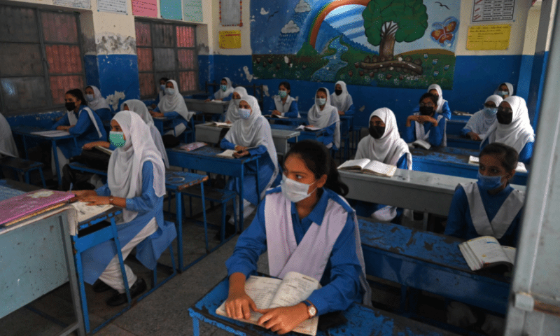 Students attend their class at a school in Lahore, as the government reopened educational institutes from grade 9th to 12th. &mdash; AFP