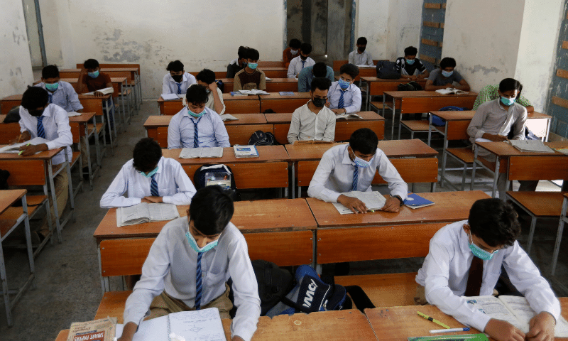 Students wearing face masks to help prevent the spread of the coronavirus attend class at a school in Lahore. &mdash; AP