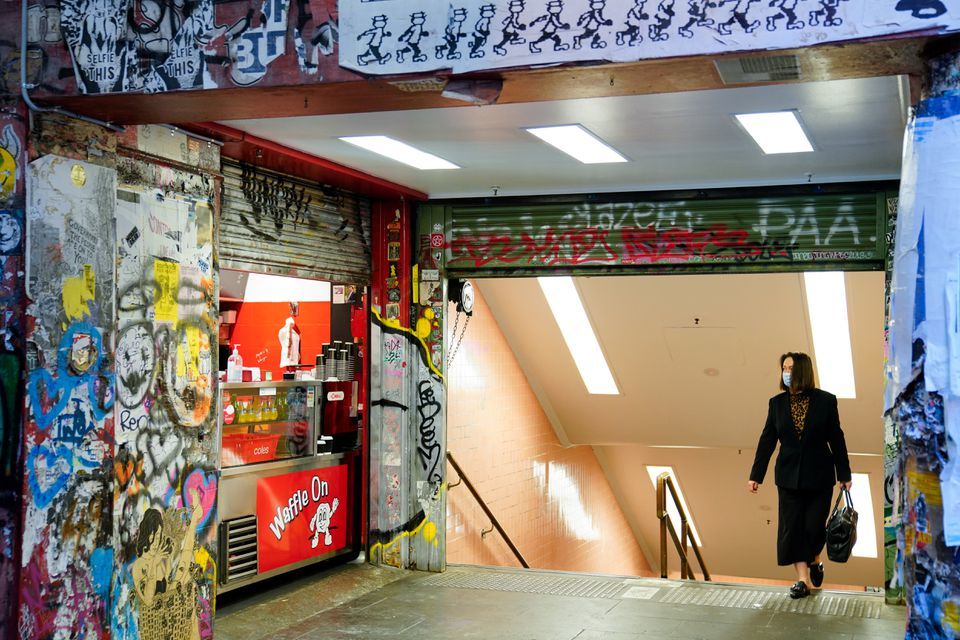 A woman walks past an empty cafe during morning commute hours on the first day of a seven-day lockdown as the state of Victoria looks to curb the spread of a coronavirus outbreak in Melbourne, Australia, May 28. &mdash; Reuters