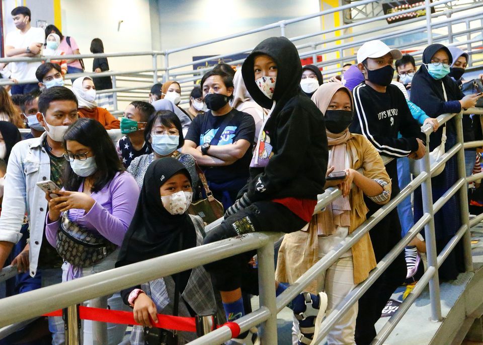 People wearing protective face masks wait for their turn to ride go-karts at Trans Studio, Jakarta, Indonesia, June 1. — Reuters