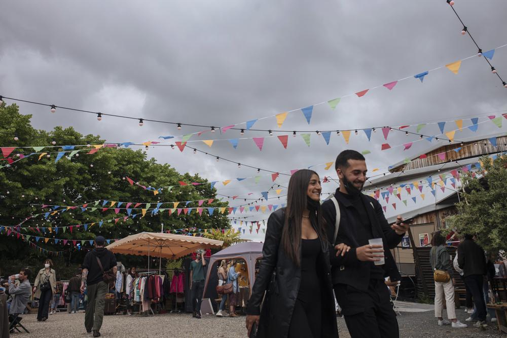 People enjoy the outdoors at a cafe terrace in Paris, France, June 5. — AP