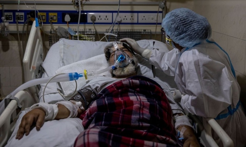 A medical worker tends to a patient suffering from Covid-19, inside the ICU ward at Holy Family Hospital in New Delhi, India, April 29. &mdash; Reuters