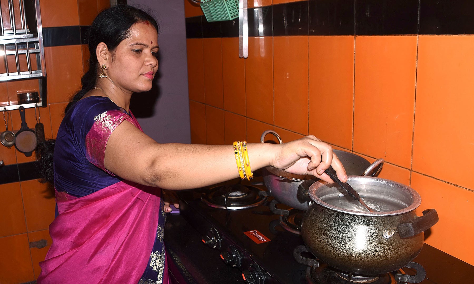 In this picture taken on June 4, 2021 Tanya Ashnigdh, who is in her fourth month of pregnancy, cooks at her home in Muzaffarpur city in the eastern state of Bihar. Ashnigdh is frightened, one of millions of expectant mothers excluded from India's faltering vaccination drive despite being at greater risk from Covid-19. — AFP