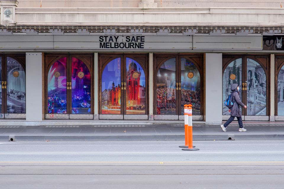 A woman walks past a "Stay Safe Melbourne" sign on a mostly-empty city centre street on the first day of a seven-day lockdown as the state of Victoria looks to curb the spread of a coronavirus outbreak, in Melbourne, Australia, May 28. — Reuters