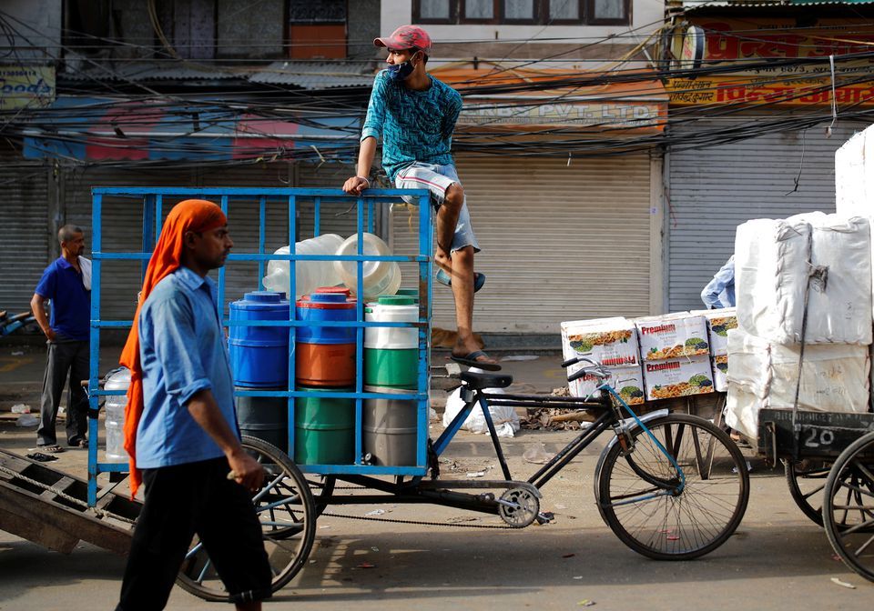 A man sits on a cycle rickshaw at a wholesale market after authorities eased lockdown restrictions that were imposed to slow the spread of the coronavirus, in the old quarters of Delhi, India, June 8. &mdash; Reuters