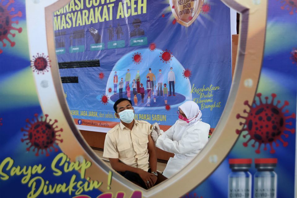 A man receives a dose of China's Sinovac Biotech vaccine during a mass vaccination programme rollout in Banda Aceh, Indonesia, June 8. — Reuters