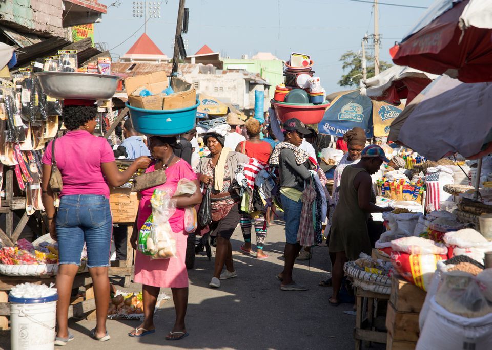 People walk in a market as they go about their lives in Port-au-Prince, Haiti, May 24. &mdash; Reuters