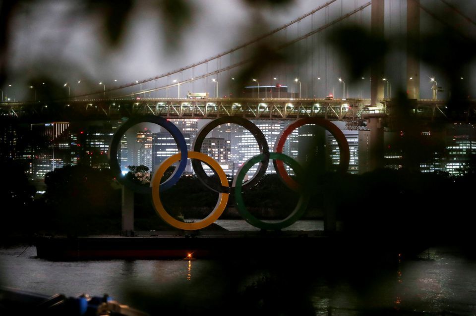 The giant Olympic rings are seen through a tree at the waterfront area of Odaiba Marine Park, Tokyo, Japan, June 3. &mdash; Reuters