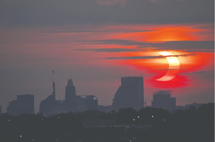 A PARTIAL solar eclipse over the skyline in Baltimore, in the US state of Maryland.—AP