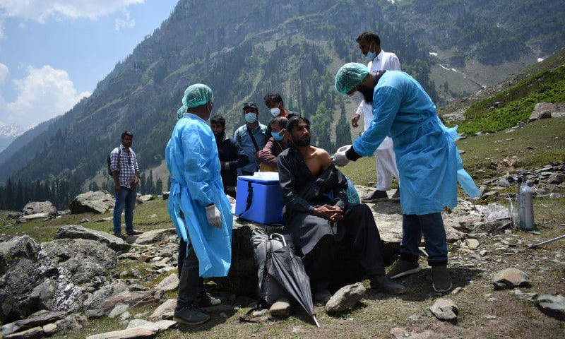 A healthcare worker administers a dose of a Covid-19 vaccine to a shepherd during a vaccination drive at Lidderwat near scenic Pahalgam in south Kashmir's Anantnag district. — Reuters