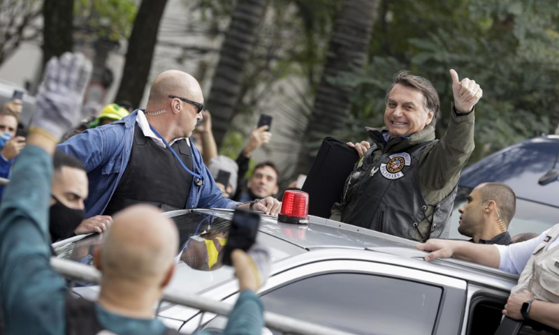 Brazil's President Jair Bolsonaro flashes a thumbs-up as he arrives to take part in caravan of motorcycle enthusiasts in a show of support for Bolsonaro, in Sao Paulo, Brazil. — AP