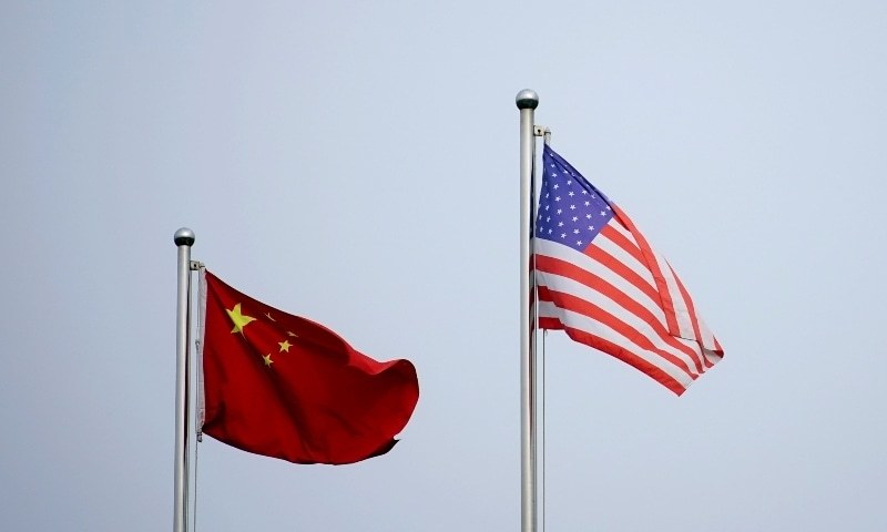 Chinese and US flags flutter outside a company building in Shanghai, China, April 14. — Reuters