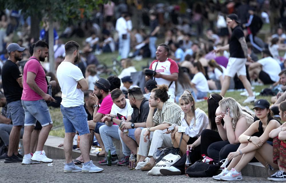 People are seen at the "Monbijoupark" (Monbijou Park) during a warm summer evening in Berlin, Germany, June 11. — AP