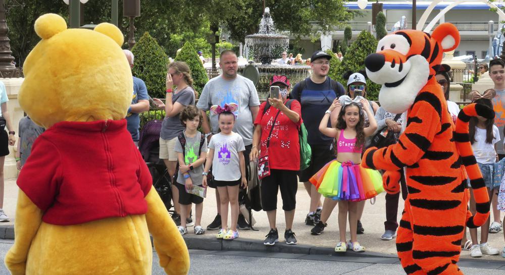 Young guests enjoy seeing Winnie The Pooh, and Tigger too, at the Magic Kingdom at Walt Disney World, in Lake Buena Vista, Florida, May 17. — AP