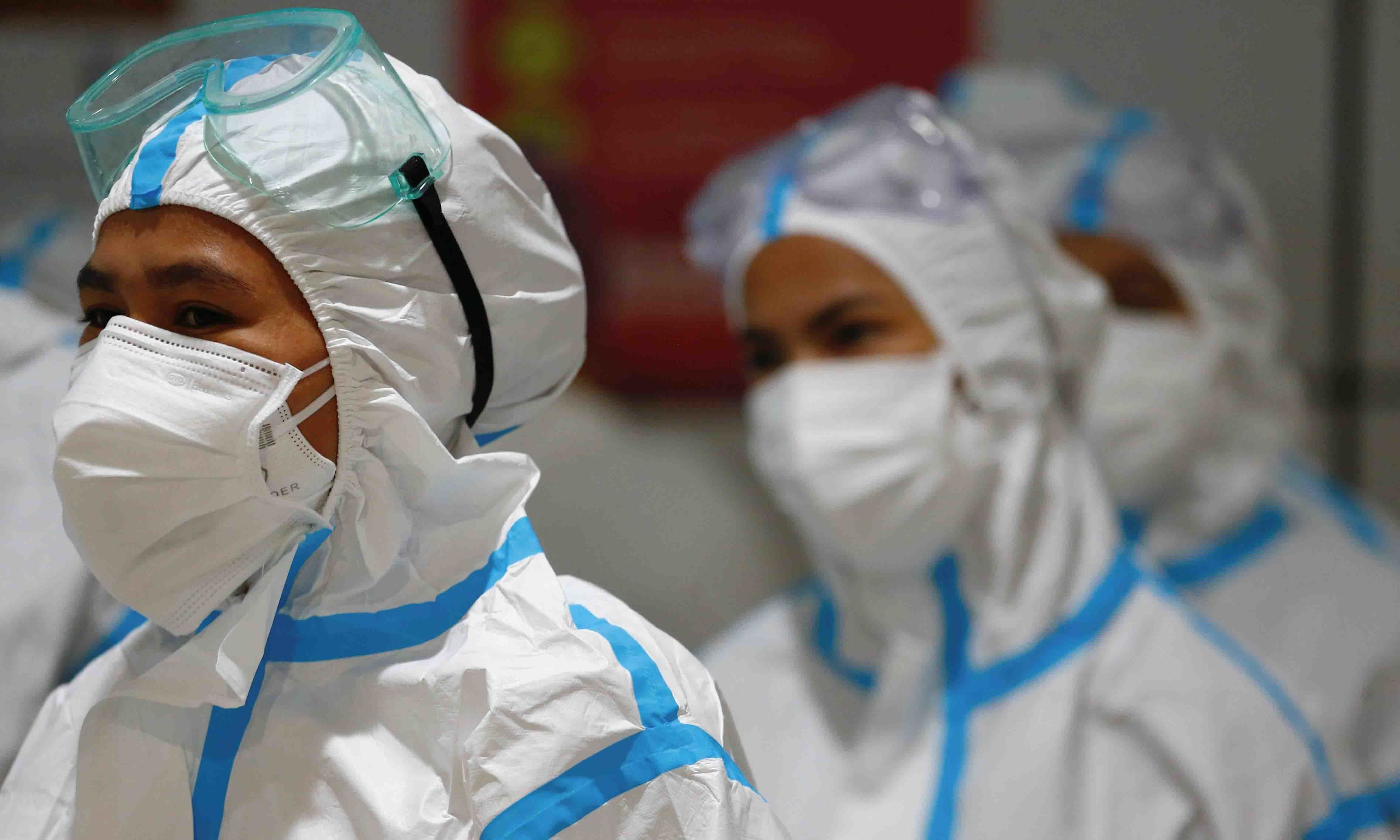 Healthcare workers wearing personal protective equipment get ready to treat patients at the emergency hospital for the coronavirus disease in Jakarta on June 17. &mdash; Reuters