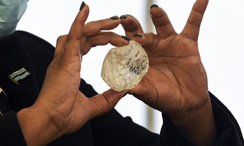 A Botswana member of cabinet holds a gem diamond in Gaborone, Botswana, on June 16, 2021. — AFP