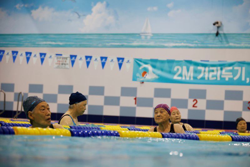 Elderly women, who have been fully vaccinated against the coronavirus, enjoy aquarobics at a pool in Seoul, South Korea, June 17. — Reuters