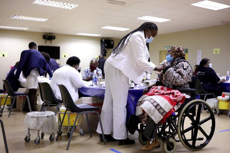 A woman receives a dose of a Covid-19 vaccine at the Munsieville Care for the Aged Centre outside Johannesburg, South Africa, May 17. — Reuters