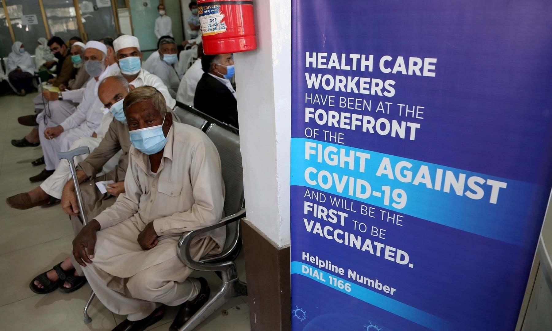 People wait their turn to receive the second shot of the Sinopharm Covid-19 vaccine at a vaccination centre in Peshawar.— AP/File