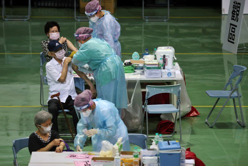 People receive a vaccine against the coronavirus during a vaccination session for elderly people over 85 years old, at a sports stadium in New Taipei City, Taiwan, June 15. — Reuters