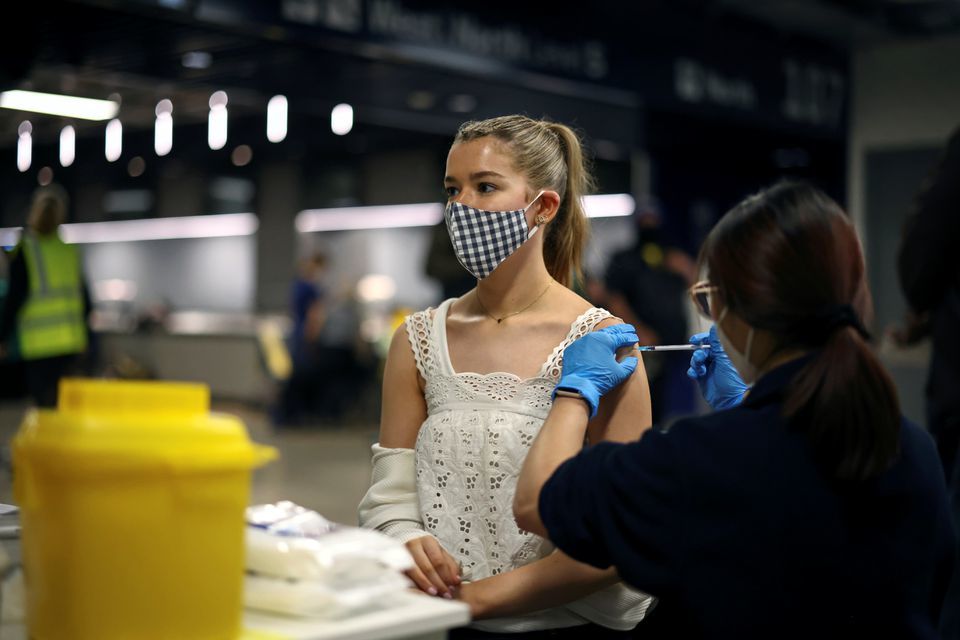A person receives a dose of the Pfizer BioNTech Covid-19 vaccine at a mass vaccination centre for those aged 18 and over at the Tottenham Hotspur Stadium, in London, Britain, June 20. &mdash; Reuters