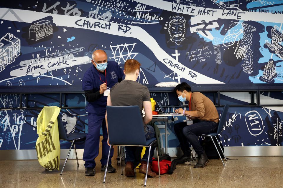 A person receives a dose of the Pfizer vaccine at a mass vaccination centre for those aged 18 and over at the Tottenham Hotspur Stadium, London, Britain, June 20. &mdash; Reuters