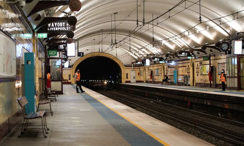 Transport workers stand on mostly deserted train platforms at the morning commute hour in the city centre during a lockdown to curb the spread of Covid-19 in Sydney, Australia. — Reuters
