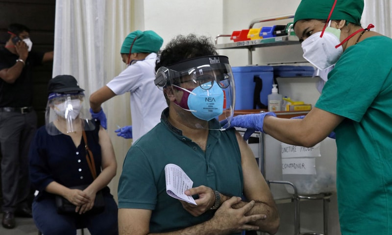 A man receives his first dose of Covishield, a Covid-19 vaccine manufactured by the Serum Institute of India, at a vaccination centre in Mumbai. — Reuters
