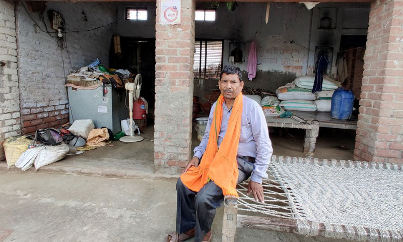 Govind Pasi, a grassroots worker for India's ruling Bharatiya Janata Party (BJP), poses outside his house in Balai village, Uttar Pradesh, India. — Reuters
