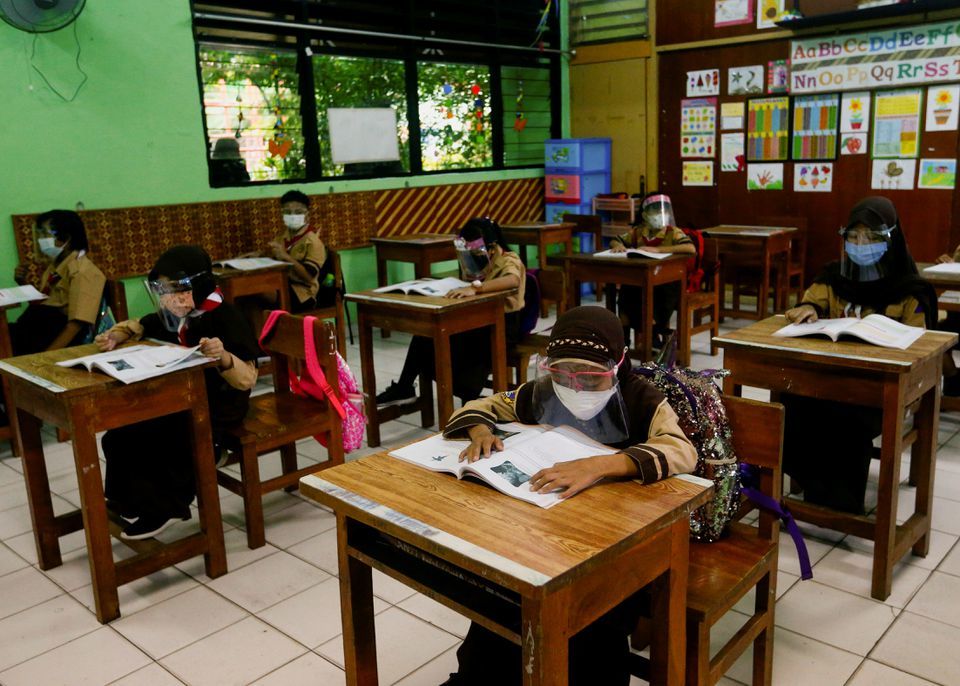 Elementary school students wearing face masks and face shields attend class, as schools reopen amid the coronavirus pandemic, in Jakarta, Indonesia, April 7. — Reuters