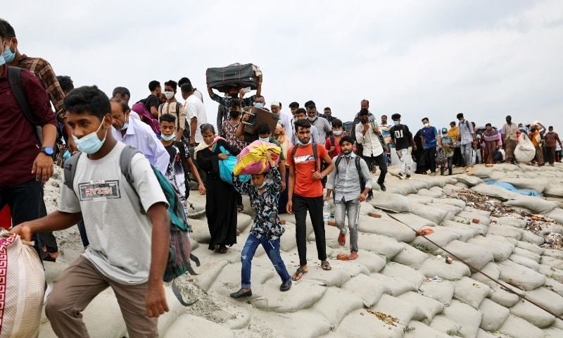 People rush to board an overcrowded ferry at the Mawa Ferry Terminal as they go home a day before a countrywide lockdown in Munshiganj, outskirts of Dhaka, June 30. — Reuters