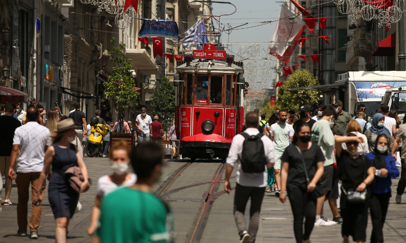 People walk on Istiklal Street, the main shopping street in Istanbul, on Thursday. &mdash; AP
