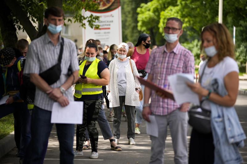 People wait in line to get a coronavirus vaccine at a vaccination centre at The Exhibition of Achievements of National Economy in Moscow, Russia, July 2. — AP