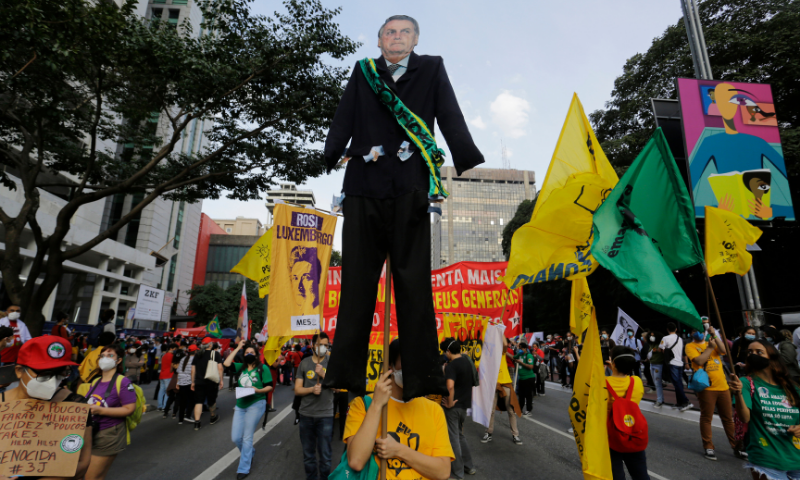 Demonstrators march on Paulista Avenue, one carrying a giant cutout of Brazilian President Jair Bolsonaro, demanding Bolsonaro resign, in Sao Paulo, Brazil. — Reuters