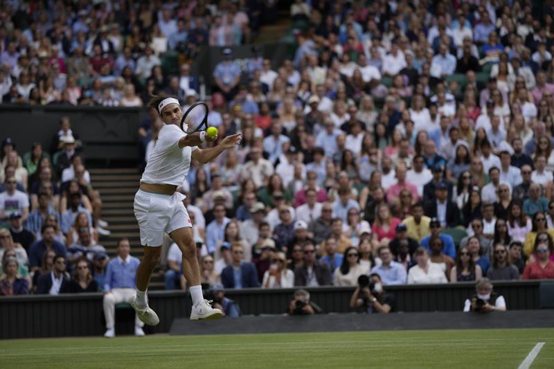 Roger Federer plays a return during the men's singles third round match against Cameron Norrie on day six of the Wimbledon Tennis Championships in London, July 3. — AP