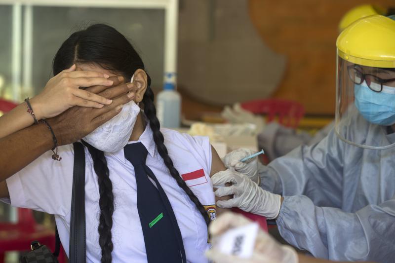 A teenager reacts as she receives a shot of the Sinovac vaccine for Covid-19 during a vaccination campaign at a school in Denpasar, Bali, Indonesia, July 5. — AP