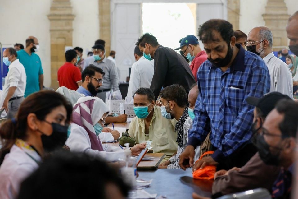 People gather to receive their coronavirus disease vaccine doses, at a vaccination center in Karachi. &mdash; Reuters/File