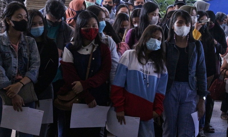 College students wearing protective face masks queue up for the coronavirus disease (COVID-19) vaccine, as cases surge in Palangkaraya, Central Kalimantan Province on July 7. — Reuters