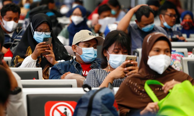 In this file photo, passengers sit at a train station as they wait to return to their hometowns ahead of Eidul Fitr amid the Covid-19 pandemic in Jakarta, Indonesia. — Reuters/File