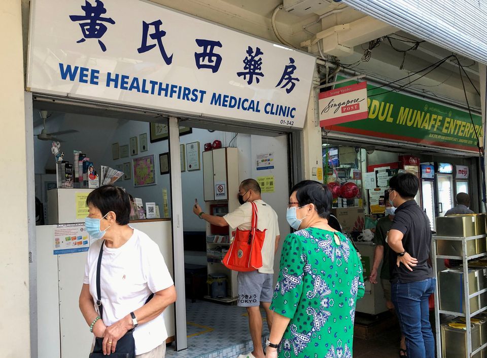 People queue to enquire about Sinovac vaccine at a clinic in Singapore, June 18. — Reuters