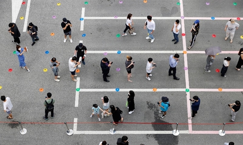 People wait in line for a coronavirus disease test at a testing site which is temporarily set up at a public health center in Seoul on July 8. &mdash; Reuters