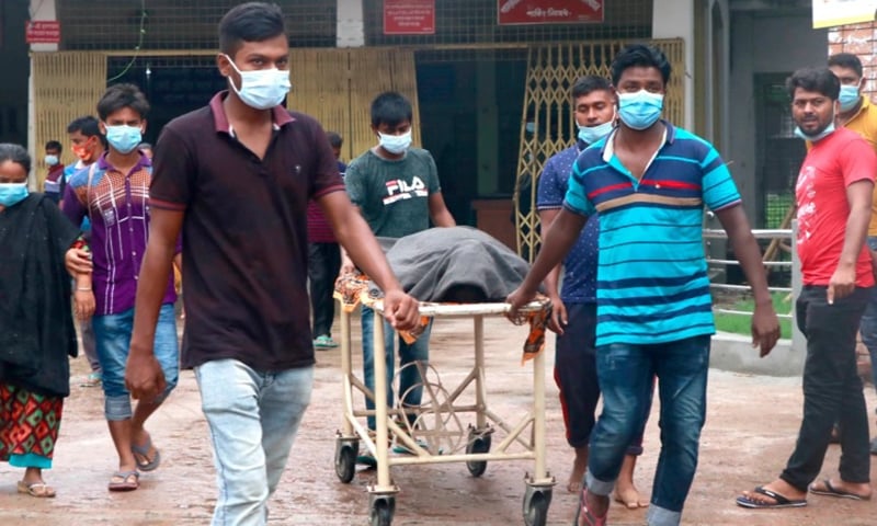 People leave a hospital with the body of a relative at the Medical College Hospital in Rajshahi, Bangladesh. — AP/File