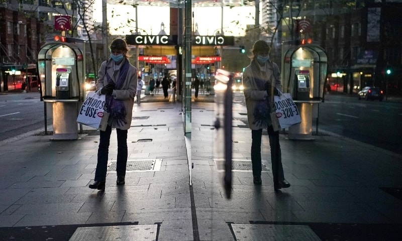 A woman wearing a protective face mask walks through the city centre during a lockdown to curb the spread of the coronavirus in Sydney on July 7. — Reuters