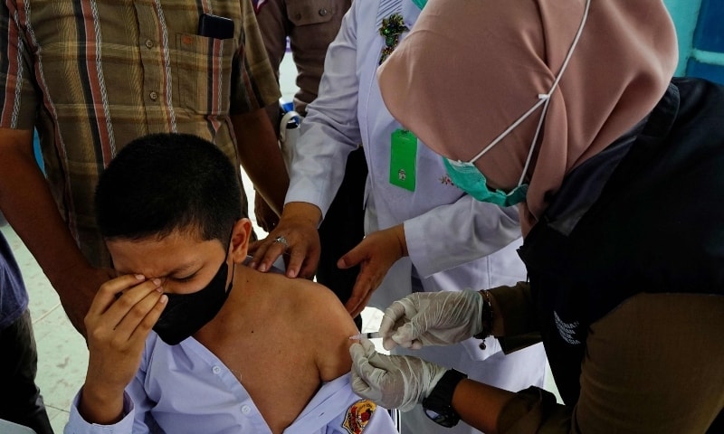 A pupil receives the Sinovac Covid-19 vaccine during a vaccination drive for Indonesian youths aged 12-18 in Lhokseumawe, Aceh, Indonesia on July 12. — AFP