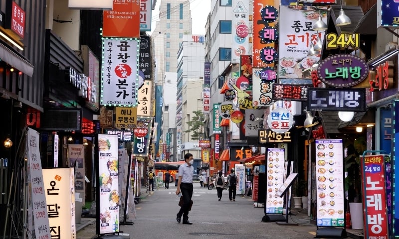 A man walks on a nearly empty street amid tightened social distancing rules due to the coronavirus disease in Seoul on July 12. &mdash; Reuters