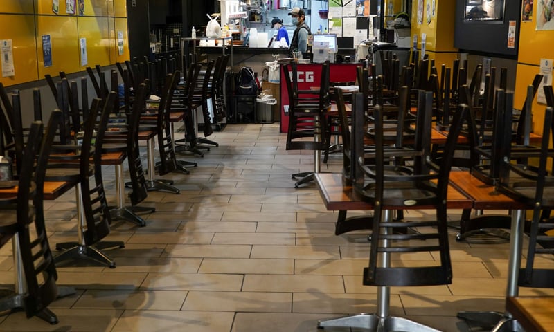 Chairs are stacked on tables inside a city centre restaurant serving takeaway but closed for dine-in during a lockdown to curb the spread of the Covid-19 outbreak in Sydney, Australia. — Reuters/File